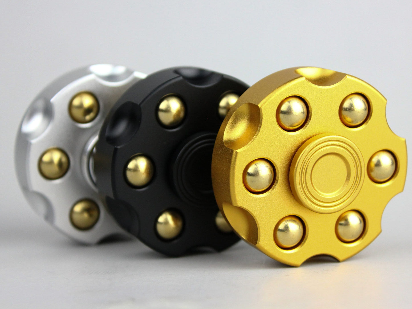 Revolver fidget spinner - brass metal with plated colored finish. Removable weights