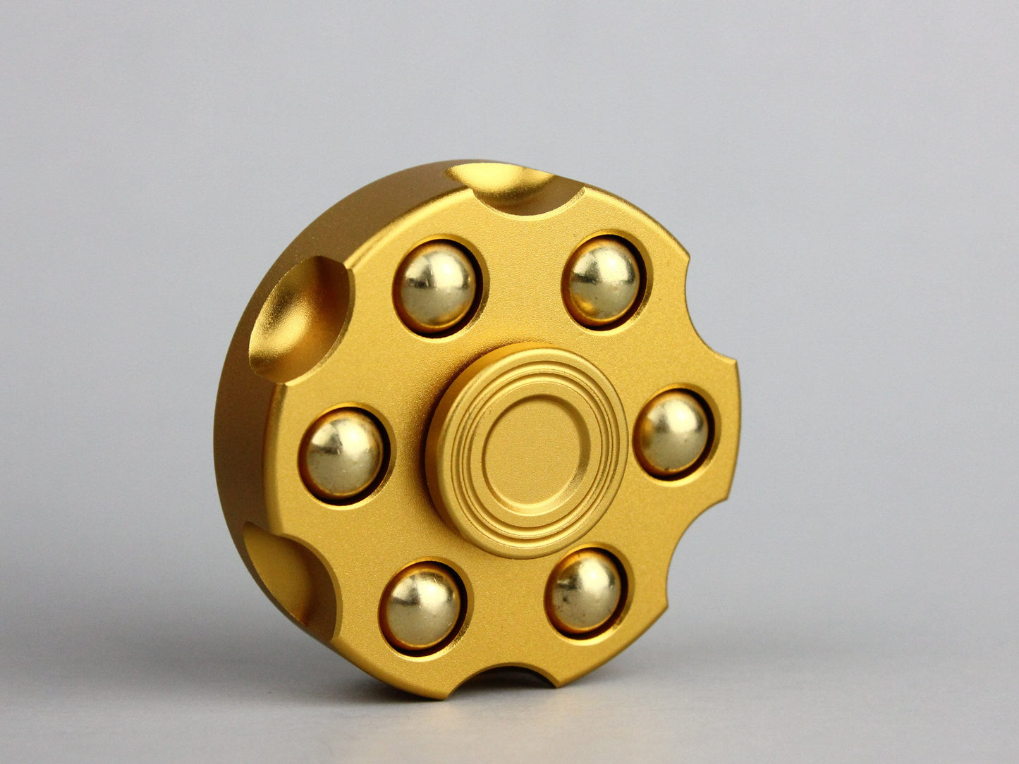 Revolver fidget spinner - brass metal with plated colored finish. Removable weights