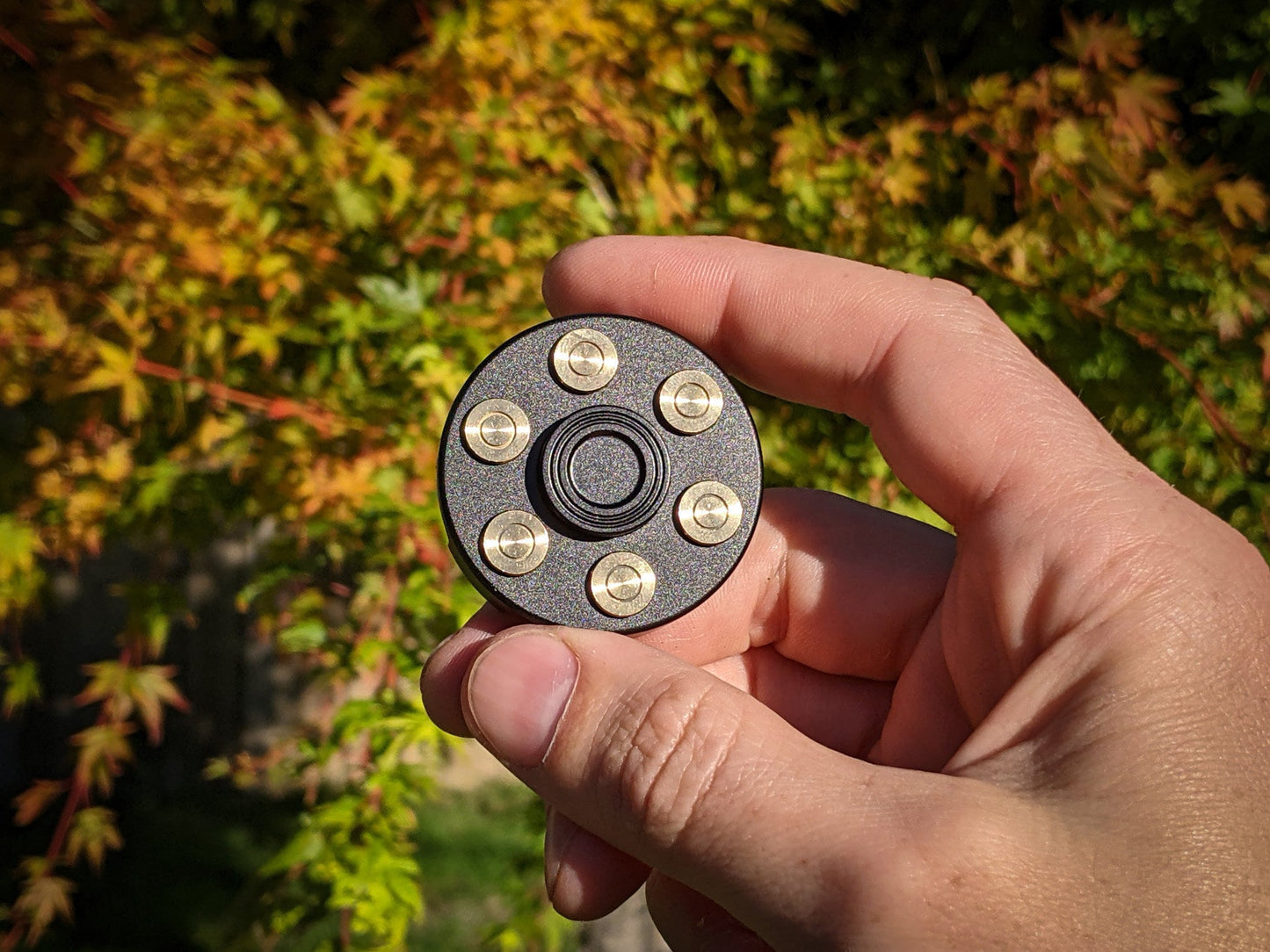 Revolver fidget spinner - brass metal with plated colored finish. Removable weights