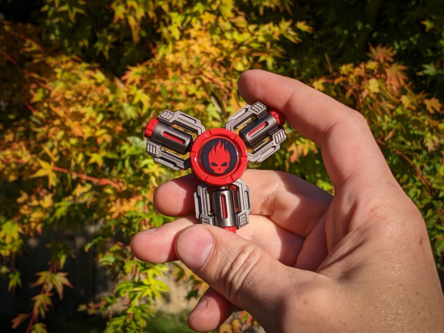 Flaming Skull 3 - tri-shaped fidget spinner in gunmetal and red