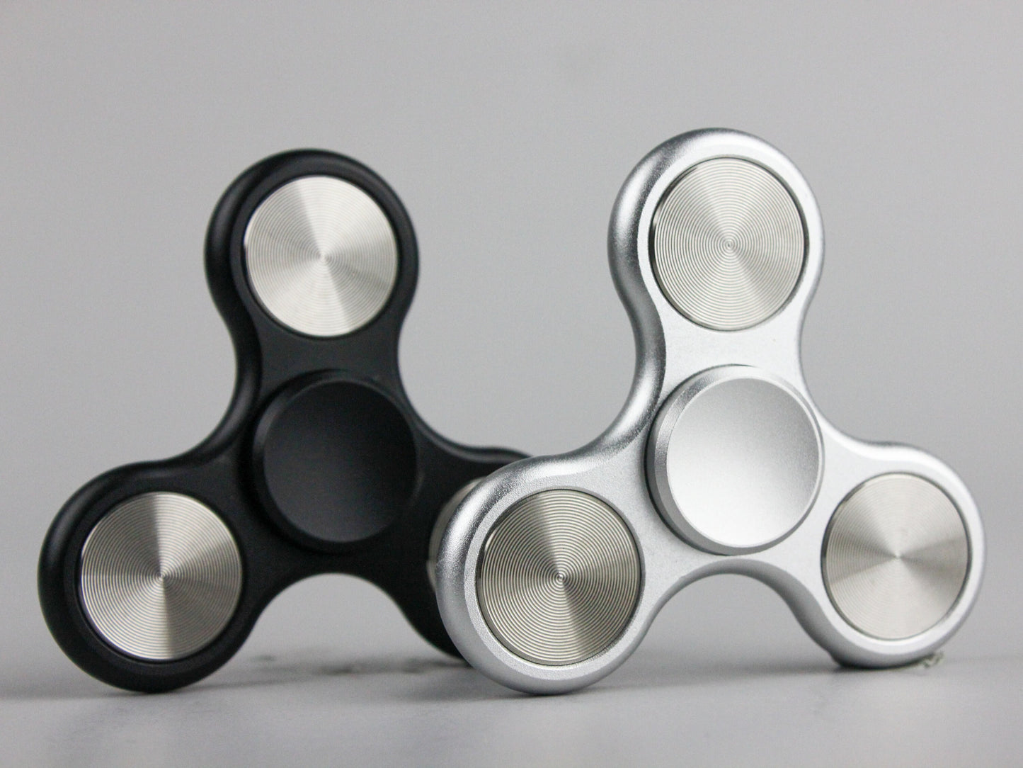 The Classic fidget spinner - tri shape metal spinner, in black, silver, blue, red, and orange