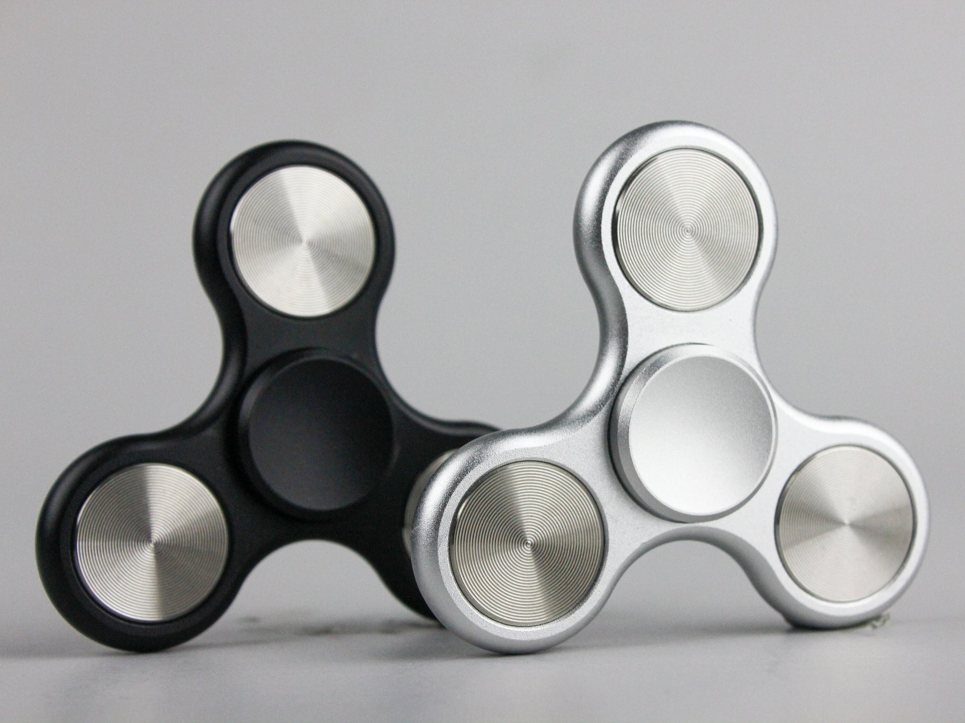 The Classic fidget spinner - tri shape metal spinner, in black, silver, blue, red, and orange
