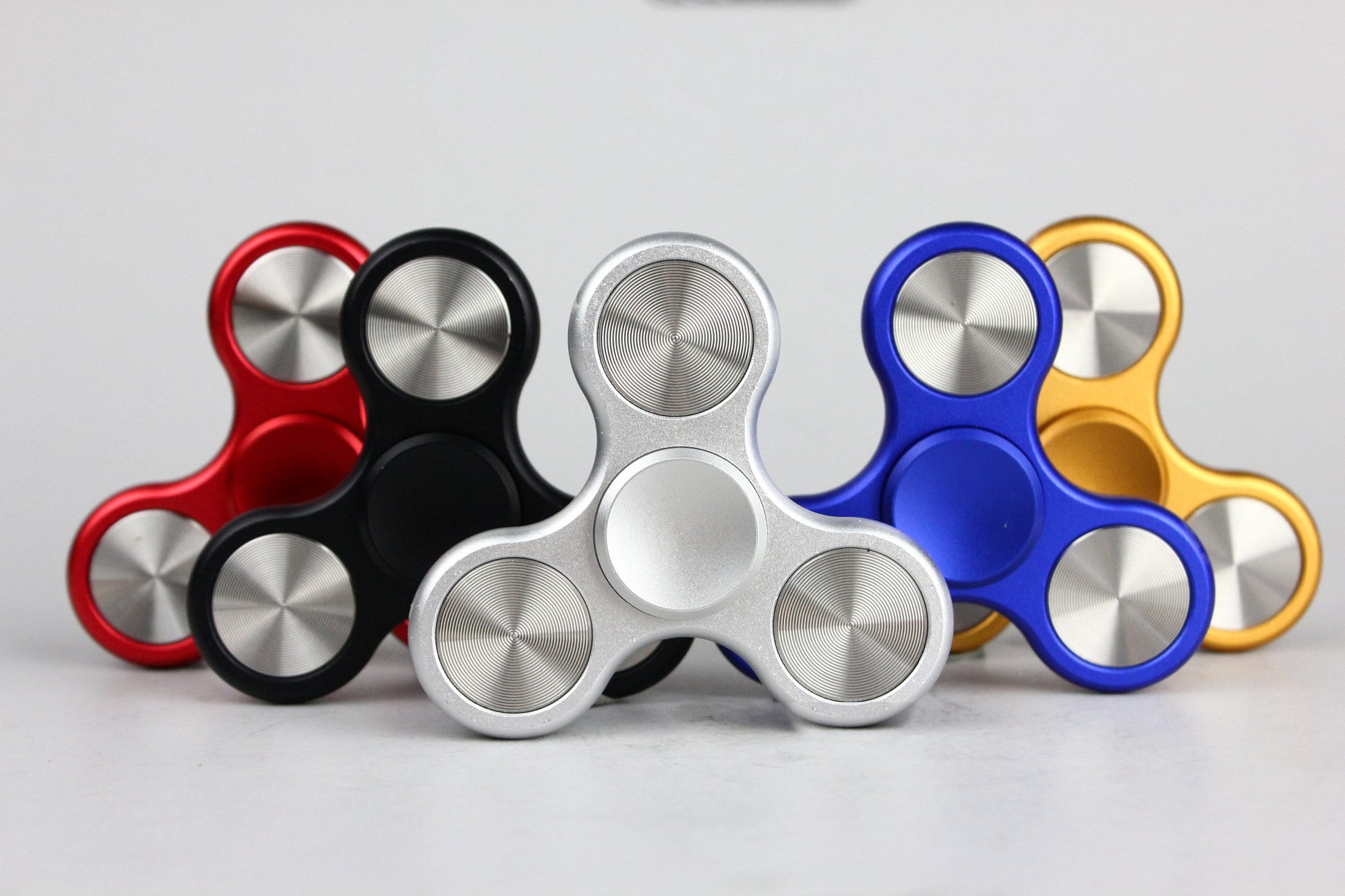 The Classic fidget spinner - tri shape metal spinner, in black, silver, blue, red, and orange